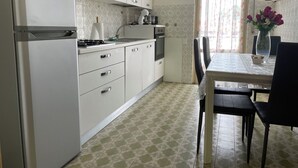 A compact kitchen with white cabinets, a built-in oven, and a gas stove. - La Casa Nel Verde - Two Bedroom Apartment, Sleeps 4 (Mede)