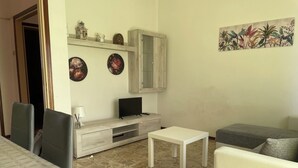 A living room with a TV, a cabinet, a coffee table, and a sofa. - La Casa Nel Verde - Two Bedroom Apartment, Sleeps 4 (Mede)