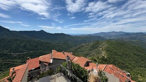 A mountainous landscape with terraced houses and a clear sky.