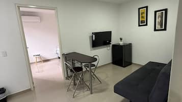 Economy Studio Suite | Living area | 42-inch Smart TV with satellite channels