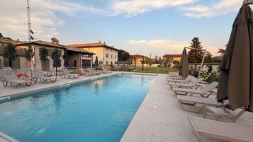 Seasonal outdoor pool, pool umbrellas, pool loungers