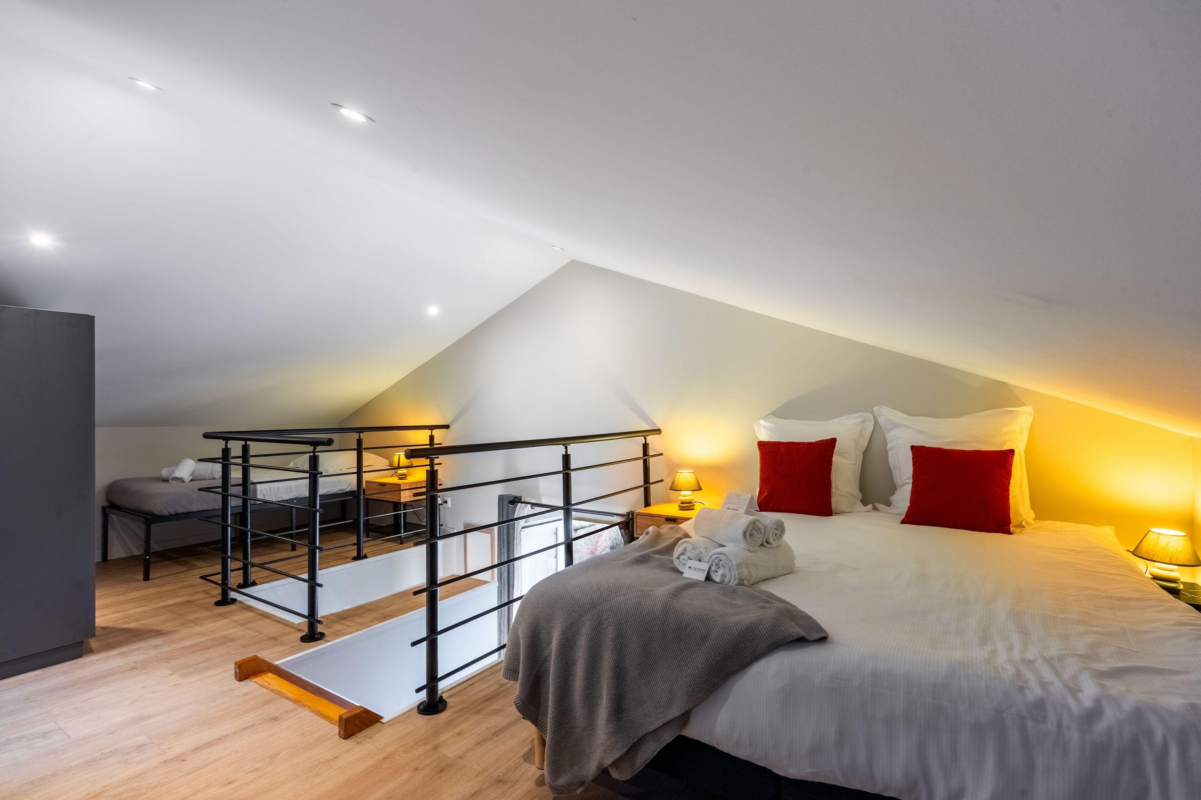 A bedroom with a bunk bed, a desk, and a chair.
