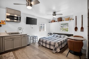A modern kitchen with a built-in microwave, a coffee maker, and a flat-screen TV. - Lamb Mountain Retreat - Pets Welcome! (Hendersonville)
