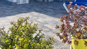 A rooftop patio with a shower, potted plants, and a pool. - Tartaga Penthouse (Adeje)