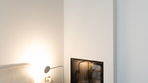 A modern bathroom with a large mirror, a wall-mounted light, and a framed picture. - Stunning two-bedroom flat in the centre of Milan (Milano)