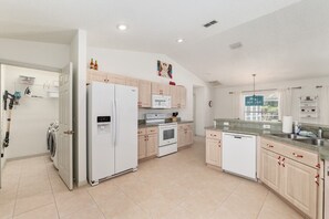 A modern kitchen with a built-in oven, microwave, and refrigerator. - Villa Bettina: 2 bedroom / 2 bathroom with pool (Inverness)