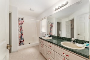 A bathroom with two sinks, a bathtub, a shower, and a large mirror. - Villa Bettina: 2 bedroom / 2 bathroom with pool (Inverness)