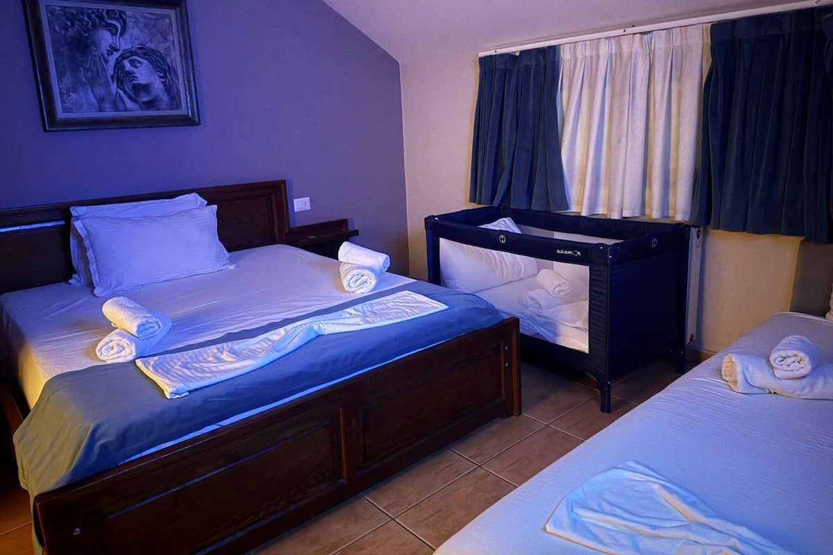 Family Triple Room, Balcony, City View | Down comforters, minibar, soundproofing, iron/ironing board