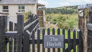 A wooden gate with a sign reading "The Hayloft." - The Hayloft (Abergele)