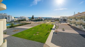 A residential area with a pool, green lawns, and a clear view of the sea. - 1-Bedroom Apartment with Sea View, Block 3-Ground Floor D, Wi-Fi and Air Conditioning (Porches)