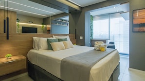 A modern hotel room with a large bed, a bedside table, a mirror, and a view of the city. - Elegance and Comfort - Close to Allianz Parque Sp-p2202b (São Paulo)