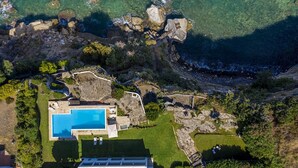 An aerial view of a coastal property with a swimming pool, rocky terrain, and lush greenery. - Villa Saracena - Seven Bedroom Villa, Sleeps 14 (Costa Saracena - Castelluccio)