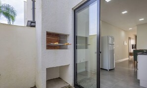 A modern kitchen with a built-in oven, a refrigerator, and a glass door leading to a balcony. - House w/ Barbecue 500 m From the Beach Cge0003 (Picarras)
