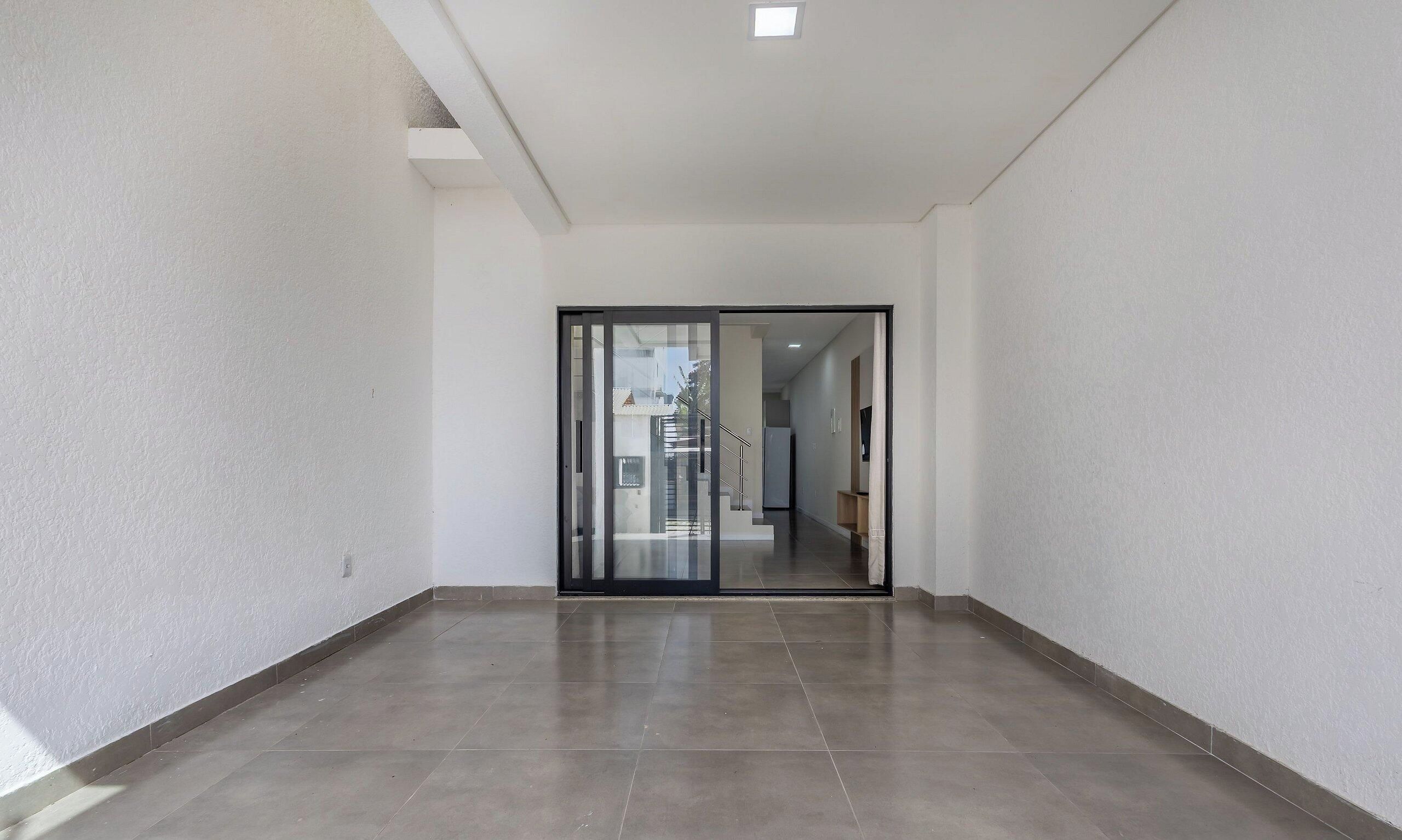 A corridor with a glass door leading to a staircase.