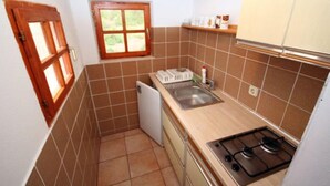 A compact kitchen with a stove, sink, and a small window. - 2 bedroom stunning apartment in Ivan Dolac (Ivan Dolac)