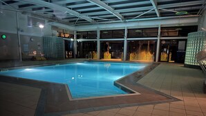An indoor swimming pool with clear water, surrounded by tiled flooring and walls. - LuxeHaven - A  Luxury Hot Tub Holiday Home at Tattershall Lakes Country Park (Tattershall)