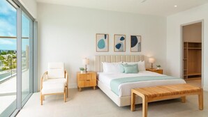 Una camera da letto moderna con un letto grande, comodini, una poltrona e un'opera d'arte appesa al muro.