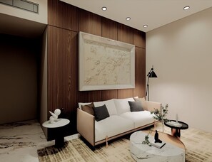 A modern living room with a beige sofa, a round coffee table, and a large framed artwork on the wall. - Hotel Ujjayanta (Ujjain)
