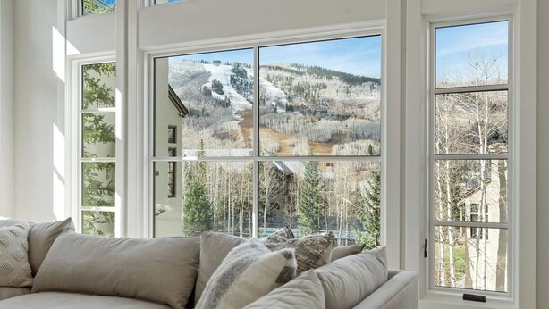 A room with a large window offering a view of a mountainous landscape. - Ski Chalet Beaver Creek - Ski In/Ski Out, Hot Tub (Beaver Creek)