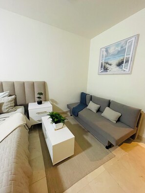 Condo, Balcony | Living area | 50-inch TV with digital channels, streaming services