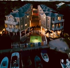 A large, multi-story building with a central courtyard and a pool. - 106- Newly Renovated House with Oceanview and Pool (Cudjoe Key)
