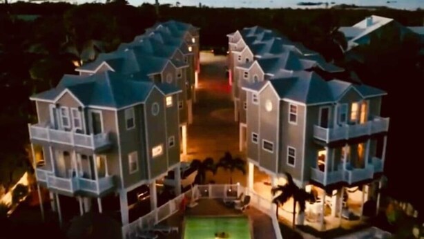 A large, multi-story building with a central courtyard and a pool. - 103- Newly Renovated House with Oceanview and Pool (Cudjoe Key)