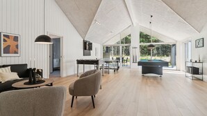 A spacious living area with a pool table, two armchairs, and a dining table. - Gorgeous home in Glesborg with sauna (Glesborg)