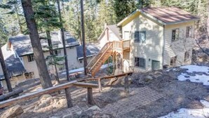 A house with a wooden deck and a staircase leading to the main entrance. - Yosemite Woods Lower Unit - Inside Yosemite (Yosemite West)