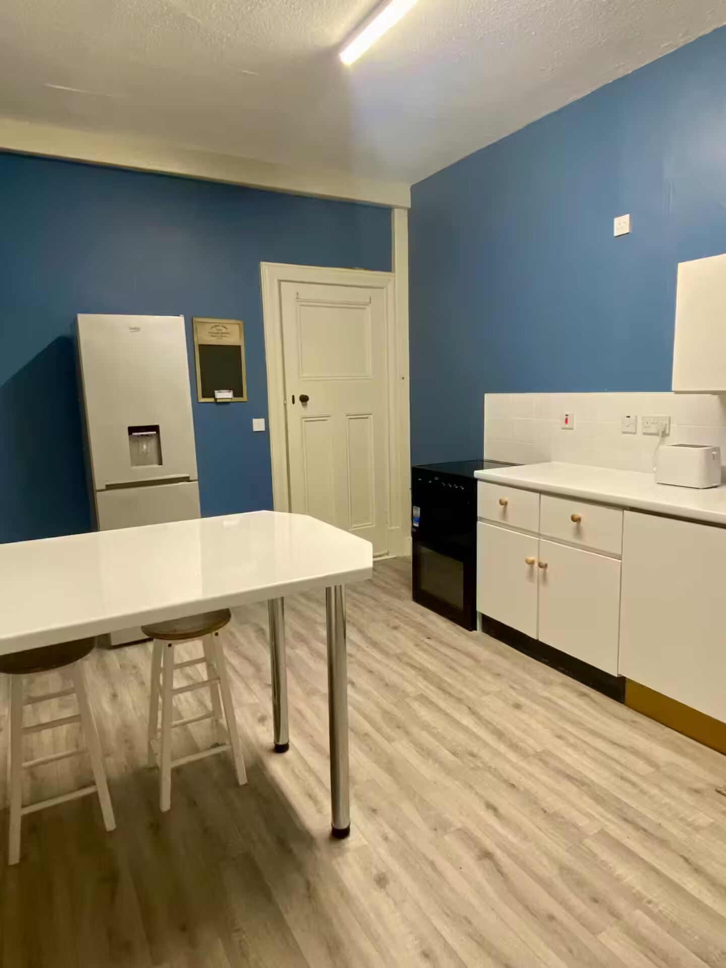 A kitchen with a white countertop, a white refrigerator, and a white dishwasher.
