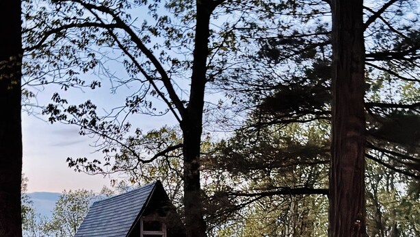 A cabin with a sloped roof, a deck, and a fire pit area. - Lovers Edge Romantic A-Frame: Hot Tub, Sauna & Fire Pit (East Stroudsburg)