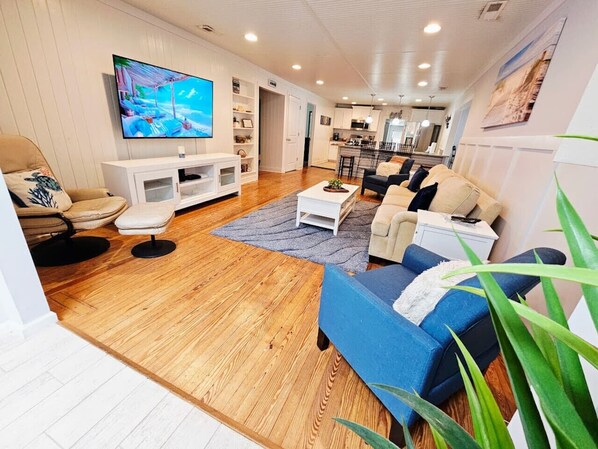 A modern living room with a TV, sofa, and coffee table.