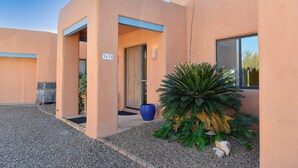 A modern building with a garage, a blue mailbox, and a large potted plant. - Sonoran Retreat w/ Hot Tub near Starr Pass Golf & Saguaro Park (Tucson)
