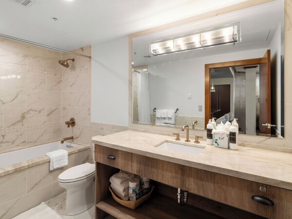 A modern bathroom with a bathtub, a toilet, a vanity with a mirror, and a shower area. - Sundial C207 | Ski-in/Ski-out | Private Balcony | Mountain Views | Pools & Hot Tubs | Ski Valet (Park City)