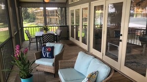 A covered porch with wicker furniture, a potted plant, and a view of the backyard. - Lakefront Retreat - 3BR/2BA Cherry Lake Home + Private Boat Dock (Madison)