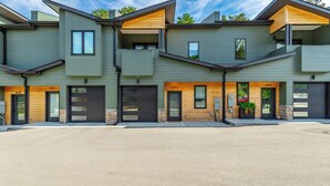 A modern multi-story residential building with a flat roof, large windows, and a clean, minimalist design. - Bespoke Outpost: A stylish 3-bedroom retreat in scenic Chattanooga, TN. (Chattanooga)