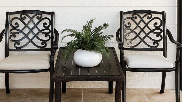 Two black metal chairs with intricate designs, a white cushioned bench, and a table with a potted plant. - Superb studio with coastal comfort in Apollo Beach, Florida (Apollo Beach)