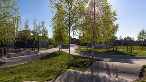 A park with a concrete skate ramp, trees, and a paved walkway. - Dünenblick 165 (Seenähe) by Interhome (Lembruch)