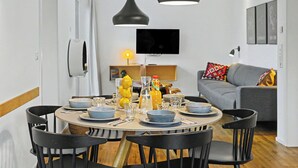 A modern dining area with a round table, black chairs, and pendant lighting. - Küstenflair 283 by Interhome (Lembruch)