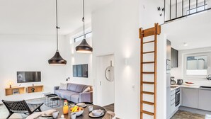 A modern apartment with a dining area, kitchen, and living space. - Zwischen den Hügeln 153 by Interhome (Lembruch)