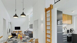 A modern kitchen with a built-in oven, a coffee maker, and a wooden ladder. - Windlicht 244 by Interhome (Lembruch)