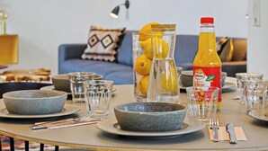 A dining table set with bowls, glasses, and a bottle of orange juice. - Windlicht 244 by Interhome (Lembruch)