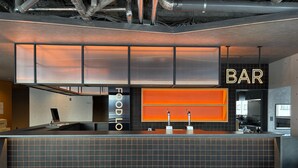 A modern bar area with a counter, a sign reading "FOODLO BAR," and a glimpse of a kitchen in the background. - THE GAKUSUI - Hostel  (Hakuba)