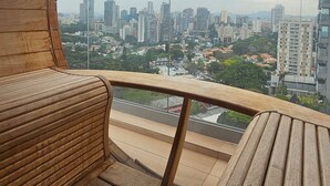 A circular wooden balcony with a view of a cityscape. - Terrae Pinheiros (São Paulo)