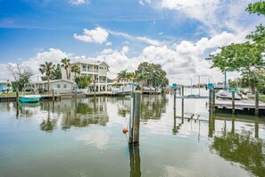 A marina with boats docked, a large house with multiple balconies, and a clear sky. - Bay side, Park side, Beach Beach Beach (Indian Rocks Beach)