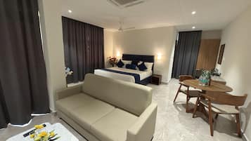 Luxury Suite, Balcony, City View | In-room safe, desk, laptop workspace, blackout drapes