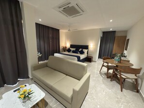 Luxury Suite, Balcony, City View | In-room safe, desk, laptop workspace, blackout drapes