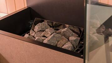 A fireplace with a stone surround and a glass enclosure.