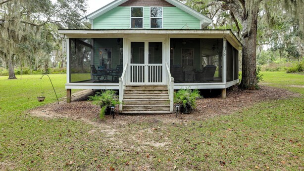 A house with a porch, a covered front area, and a small front yard. - 1/2 Mi to Sapelo River: Family Home w/ Large Yard (Shellman Bluff)