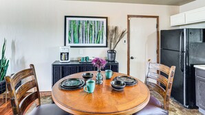 A dining area with a wooden table, chairs, and a coffee station. - Hike & Golf: Farmington Home 1 Mi to Animas River! (Farmington)