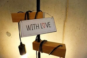 A sign with the text 'WITH LOVE' mounted on a wooden structure.